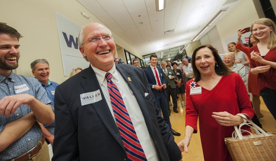 In this Tuesday, Aug. 6, 2019, photo, Republican William Waller Jr., left, and wife, Charlotte Waller, enter the Waller watch party to cheers and applause, in Jackson, Miss. The former Mississippi Supreme Court chief justice is in a runoff election against Lt. Gov. Tate Reeves, for the party's gubernatorial nomination. (Barbara Gauntt/The Clarion-Ledger via AP)