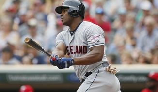 Cleveland Indians&#39; Yasiel Puig hits an RBI double off Minnesota Twins pitcher Jose Berrios in the first inning of a baseball game Sunday, Aug. 11, 2019, in Minneapolis. (AP Photo/Jim Mone)