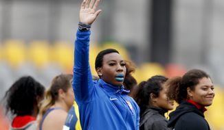 Gwendolyn Berry of United States waves prior to in the women&#39;s hammer throw final during the athletics at the Pan American Games in Lima, Peru, Saturday, Aug. 10, 2019. (AP Photo/Rebecca Blackwell)