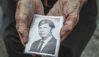 This Wednesday, Aug. 7, 2019 photo shows Brian Toale shows a photo of himself at 16 years old in New York.  Thousands of people who say they were molested as children in New York state will head to court this week to file lawsuits against their alleged abusers and the institutions where they worked.  Toale, 66, who says he was molested by an employee at a Catholic high school he attended on Long Island, was one of the leaders in the fight to pass the Child Victims Act.  (AP Photo/Bebeto Matthews)
