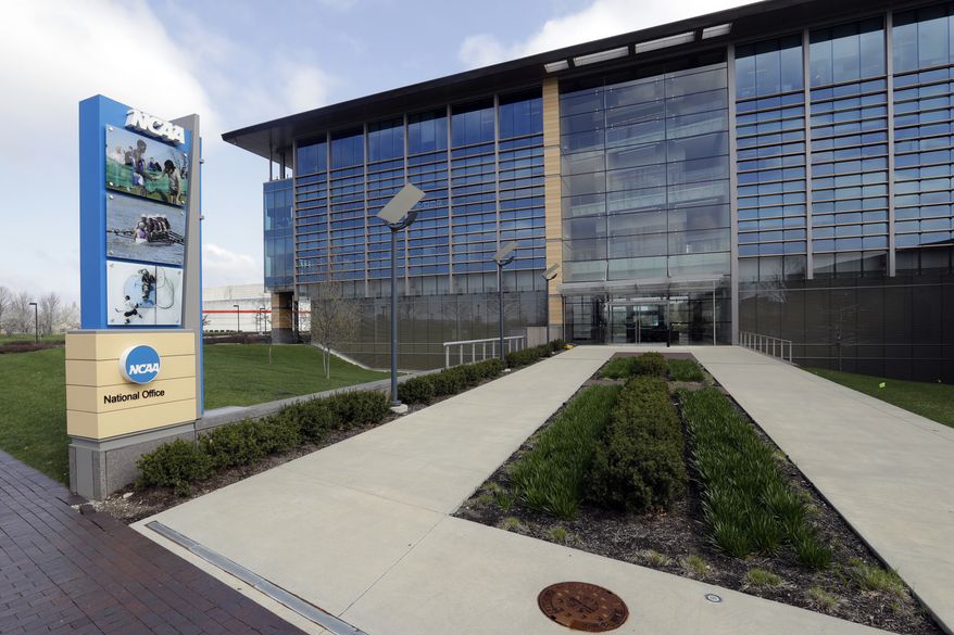 In this April 25, 2018, file photo, NCAA headquarters in Indianapolis is viewed. The NCAA has backtracked on its new agent certification standards and will no longer require a bachelor's degree for those who will be permitted to represent a student-athlete. (AP Photo/Darron Cummings, File) **FILE**