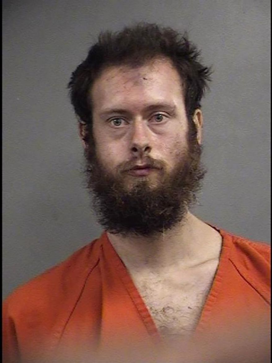 In this undated photo released by the Louisville Metro Corrections, Cane L. Madden poses for a booking photo, in Louisville, Ky. Police say 29-year-old Madden hit an 8-year-old girl in the head with a shovel, fracturing her skull, and then raped and robbed her. (Louisville Metro Corrections via AP)