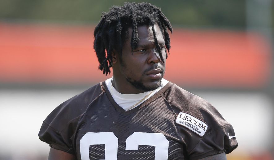 FILE - In this Aug. 14, 2018, file photo, Cleveland Browns defensive end Chad Thomas walks out to the field during NFL football training camp in Berea, Ohio. Browns defensive end Chad Thomas sustained a neck injury in practice Monday, Aug. 12, 2019, and is undergoing further tests at a hospital.(AP Photo/Ron Schwane, File)