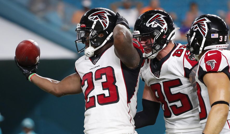 Atlanta Falcons running back Brian Hill (23) celebrates with tight end Eric Saubert (85) after scoring a touchdown during the first half of the team's preseason NFL football game against the Miami Dolphins, Thursday, Aug. 8, 2019, in Miami Gardens, Fla. (AP Photo/Wilfredo Lee)