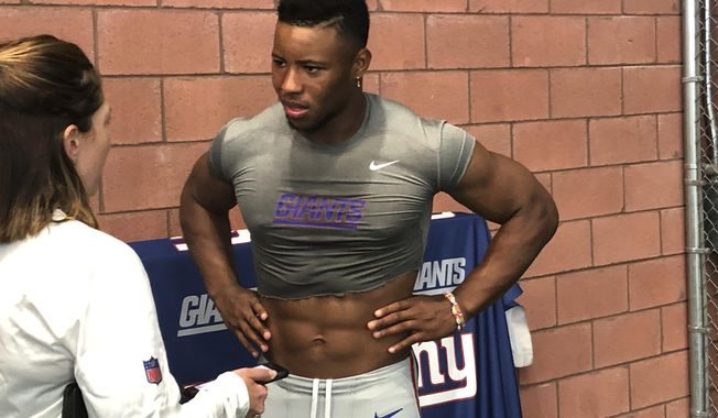 New York Giants NFL football player Saquon Barkley talks to the media after practice in East Rutherford, N.J., Monday, Aug. 12, 2019. (AP Photo/Tom Canavan)