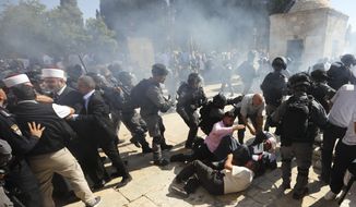 Israeli police clashes with Palestinian worshippers at al-Aqsa mosque compound in Jerusalem, Sunday, Aug 11, 2019. Clashes have erupted between Muslim worshippers and Israeli police at a major Jerusalem holy site during prayers marking the Islamic holiday of Eid al-Adha. (AP Photo/Mahmoud Illean)