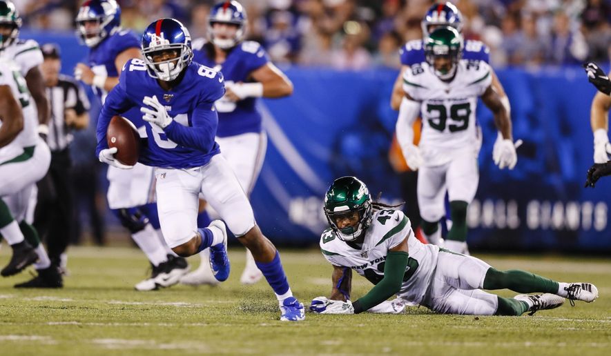 New York Jets defensive back Parry Nickerson (43) watches as New York Giants' Russell Shepard (81) runs for a touchdown during the first half of a preseason NFL football game Thursday, Aug. 8, 2019, in East Rutherford, N.J. (AP Photo/Michael Owens)