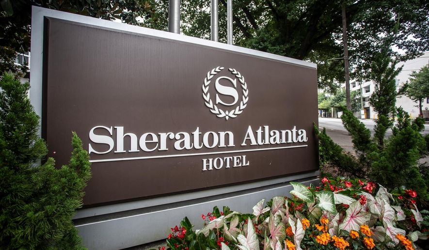 FILE-In this Wednesday, July 31, 2019 file photo, the sign at the entrance to the Sheraton Atlanta Hotel is seen, in Atlanta. A lawsuit alleges "negligence in the operation and maintenance of the water systems" caused a Legionnaires' disease outbreak at a downtown Atlanta hotel. The lawsuit was filed Monday in Gwinnett County State Court by Germany Greer, who says he tested positive for the disease after attending a conference at the Sheraton Atlanta Hotel June 27-July 1. (AP Photo/Ron Harris, File)