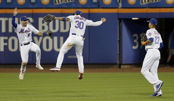 New York Mets outfielders Jeff McNeil, left, Michael Conforto, center, and Aaron Altherr celebrate after a baseball game against the Washington Nationals, Saturday, Aug. 10, 2019, in New York. (AP Photo/Seth Wenig)