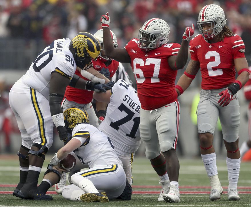 In this Saturday, Nov. 24, 2018, photo, Ohio State defensive lineman Robert Landers (67) celebrates his sack on Michigan quarterback Shea Patterson (2) in the first half of an NCAA college football game in Columbus, Ohio. Robert Landers struggles with mental illness, and he doesn’t care who knows it. In fact, he wants more people to know it. He took to Twitter in the aftermath of the mass shooting in his hometown of Dayton to make his struggle public, understanding that survivors of the shooting and others may have issues to contend with. (Marvin Fong/The Plain Dealer via AP)