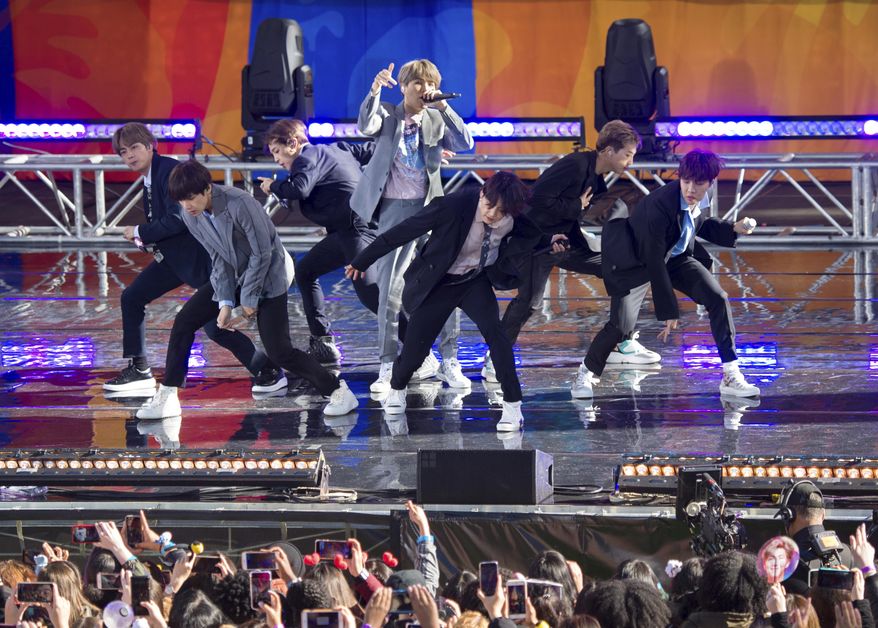 FiLE - In this May 15, 2019, file photo, South Korean boy band BTS perform on ABC&#x27;s &amp;quot;Good Morning America at Rumsey Playfield/SummerStage in Central Park, in New York. The agency for K-pop superstars BTS says the singers will take an extended break from showbiz to rest and relax and “enjoy the ordinary lives of young people in their 20s, albeit briefly.” Big Hit Entertainment said a concert on Monday, Aug. 12, 2019, in Seoul was group’s last scheduled event before the seven members go on “vacations” for the first time since their 2013 debut. (Photo by Scott Roth/Invision/AP, File)