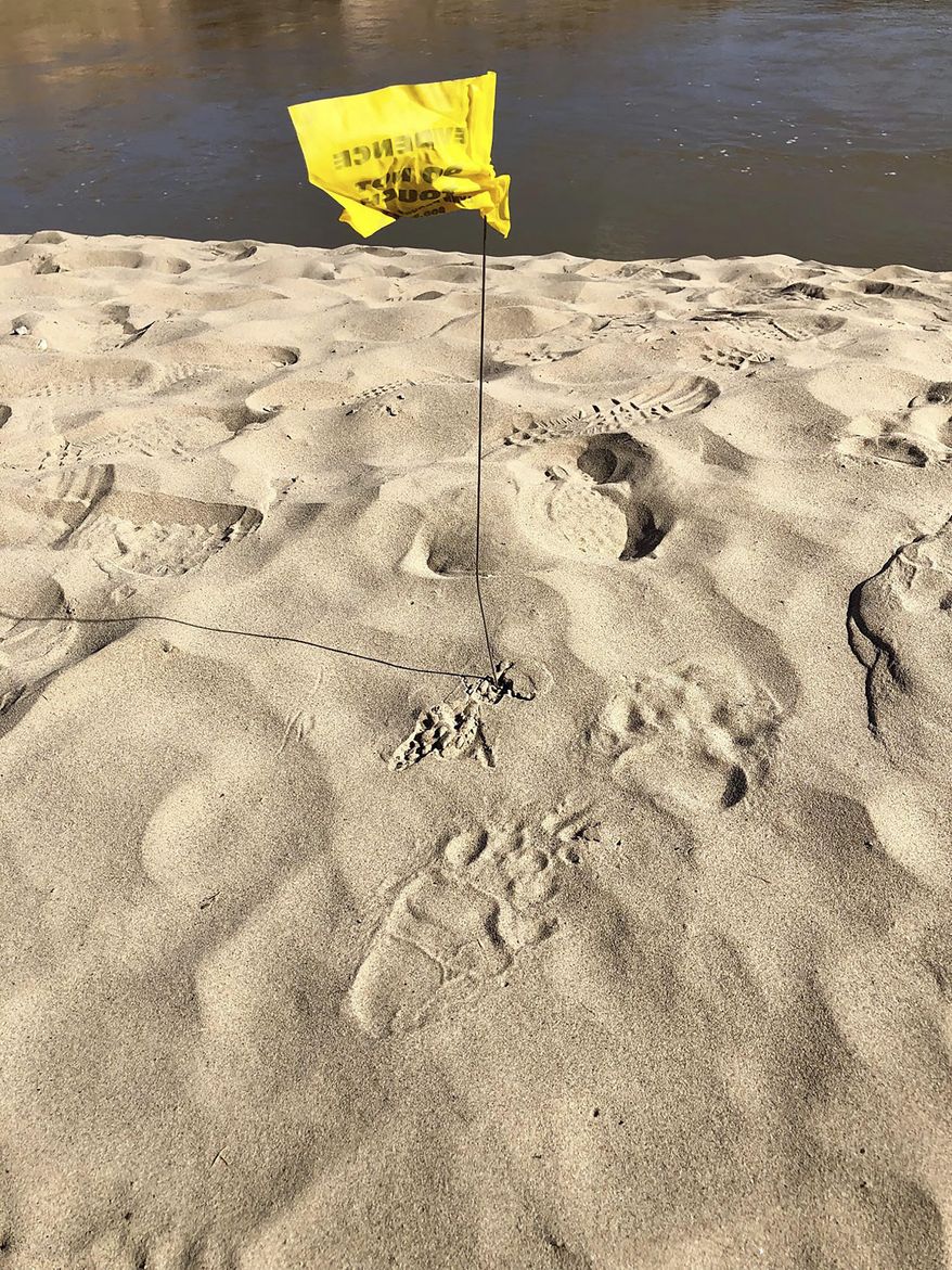 In this photo provided by the the Utah Division of Wildlife Resources bear tracks are seen close to a campground along the Colorado River near Moab, Utah, Friday, Aug. 9, 2019. Wildlife officials say they are still looking for the bear that attacked a 13-year-old boy at a campground in eastern Utah. The state's Division of Wildlife Resources said the teenager was sleeping at a campground along the Colorado River Friday morning when a bear approached him and bit his ear and cheek. The boy, whose name hasn't been released, has been treated and released from the hospital for minor injuries. Officials said they are still working to track down the bear. (Aaron Bott/The Utah Division of Wildlife Resources via AP)