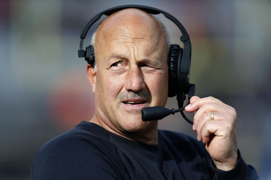 FILE - In this Oct. 13, 2018, Boston College head coach Steve Addazio talks on his headset during the second half of an NCAA college football game against Louisville in Boston. (AP Photo/Michael Dwyer, File)