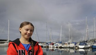Greta Thunberg poses for a picture in the Marina where the boat Malizia is moored in Plymouth, England Tuesday, Aug. 13, 2019. Greta Thunberg, the 16-year-old climate change activist who has inspired student protests around the world, is heading to the United States this week - in a sailboat. (AP Photo/Kirsty Wigglesworth)