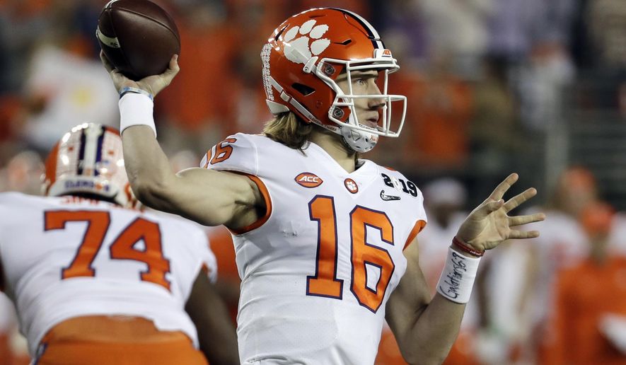 FILE - In this Jan. 7, 2019, file photo, Clemson's Trevor Lawrence throws during the first half the NCAA college football playoff championship game against Alabama, in Santa Clara, Calif. Sure, Clemson lost all four of its “Power Rangers” defensive line and seven starters on defense from its title team. But the Tigers’ offense, led by Heisman Trophy candidates quarterback Trevor Lawrence and tailback Travis Etienne, looks ready to operate at an even higher level than a year ago when it averaged 527 yards and 44.3 points a game. (AP Photo/Chris Carlson, File)