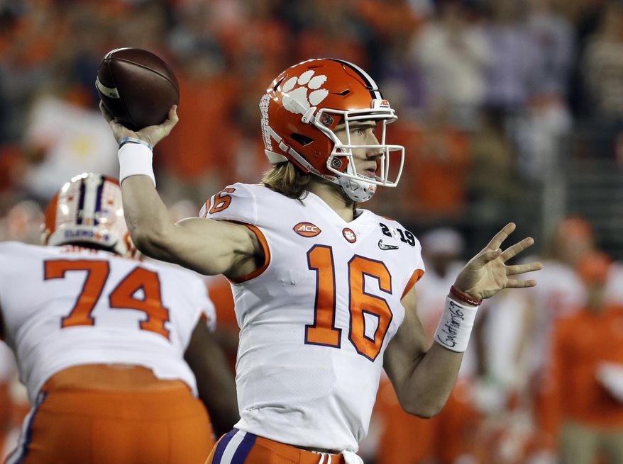 FILE - In this Jan. 7, 2019, file photo, Clemson's Trevor Lawrence throws during the first half the NCAA college football playoff championship game against Alabama, in Santa Clara, Calif. Sure, Clemson lost all four of its “Power Rangers” defensive line and seven starters on defense from its title team. But the Tigers’ offense, led by Heisman Trophy candidates quarterback Trevor Lawrence and tailback Travis Etienne, looks ready to operate at an even higher level than a year ago when it averaged 527 yards and 44.3 points a game. (AP Photo/Chris Carlson, File)