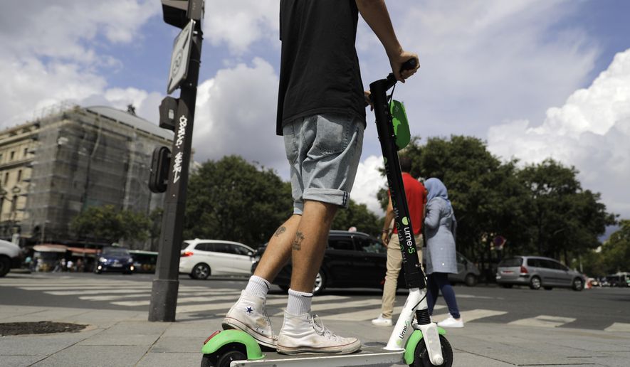 A man rides an electric scooter in Paris, Monday, Aug. 12, 2019. The French government is meeting with people who&#x27;ve been injured by electric scooters as it readies restrictions on vehicles that are transforming the Paris cityscape. The Transport Ministry says Monday&#x27;s closed-door meeting is part of consultations aimed at limiting scooter speeds and where users can ride and park them. (AP Photo/Lewis Joly)