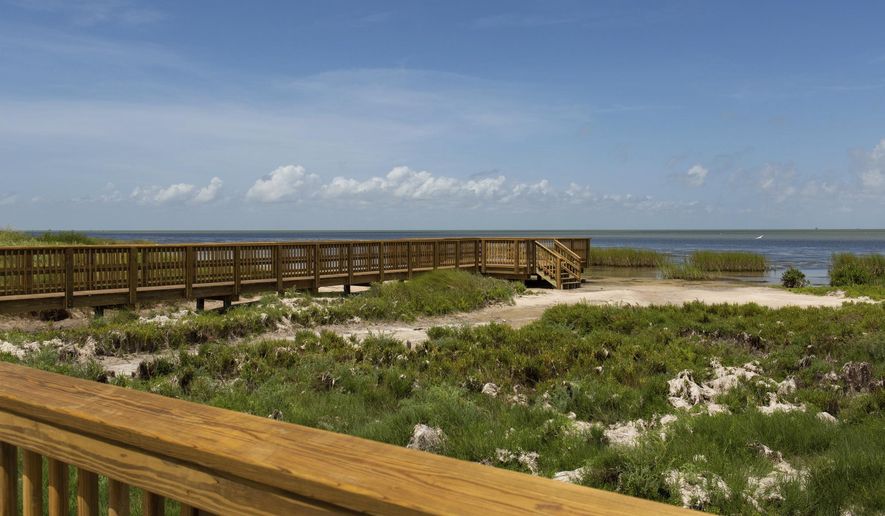 In this Aug. 7, 2019 photo, the newly renovated boardwalk at the Aransas National Wildlife Refuge in Austwell, Texas, connects the observation towers and the Big Tree Trail along the San Antonio Bay. (Emree Weaver/The Victoria Advocate via AP)