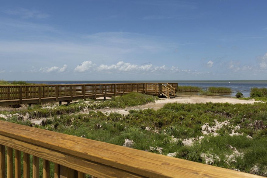 In this Aug. 7, 2019 photo, the newly renovated boardwalk at the Aransas National Wildlife Refuge in Austwell, Texas, connects the observation towers and the Big Tree Trail along the San Antonio Bay. (Emree Weaver/The Victoria Advocate via AP)