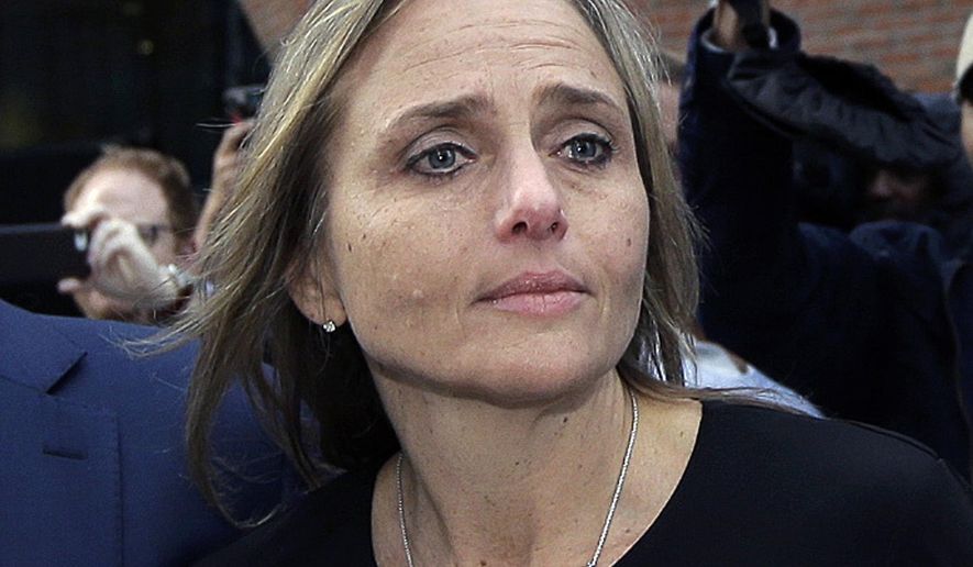 FILE - In this April 25, 2019 file photo, district court judge Shelley M. Richmond Joseph departs federal court in Boston after facing obstruction of justice charges for allegedly helping a man in the country illegally evade immigration officials as he left her Newton, Mass., courthouse after a 2018 hearing. The state Supreme Judicial Court reversed course Tuesday, Aug. 13, and ruled that Joseph, who has been suspended, can collect her annual salary and ordered her to receive back pay dating to late April. (AP Photo/Steven Senne, File)