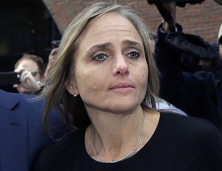 FILE - In this April 25, 2019 file photo, district court judge Shelley M. Richmond Joseph departs federal court in Boston after facing obstruction of justice charges for allegedly helping a man in the country illegally evade immigration officials as he left her Newton, Mass., courthouse after a 2018 hearing. The state Supreme Judicial Court reversed course Tuesday, Aug. 13, and ruled that Joseph, who has been suspended, can collect her annual salary and ordered her to receive back pay dating to late April. (AP Photo/Steven Senne, File)