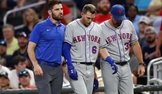 New York Mets&#x27; Jeff McNeil (6) is helped off the field by a trainer and manager Mickey Callaway (36) after being injured running out a ground ball during the ninth inning of the team&#x27;s baseball game against the Atlanta Braves on Tuesday, Aug. 13, 2019, in Atlanta. The Braves won 5-3. (AP Photo/John Bazemore)