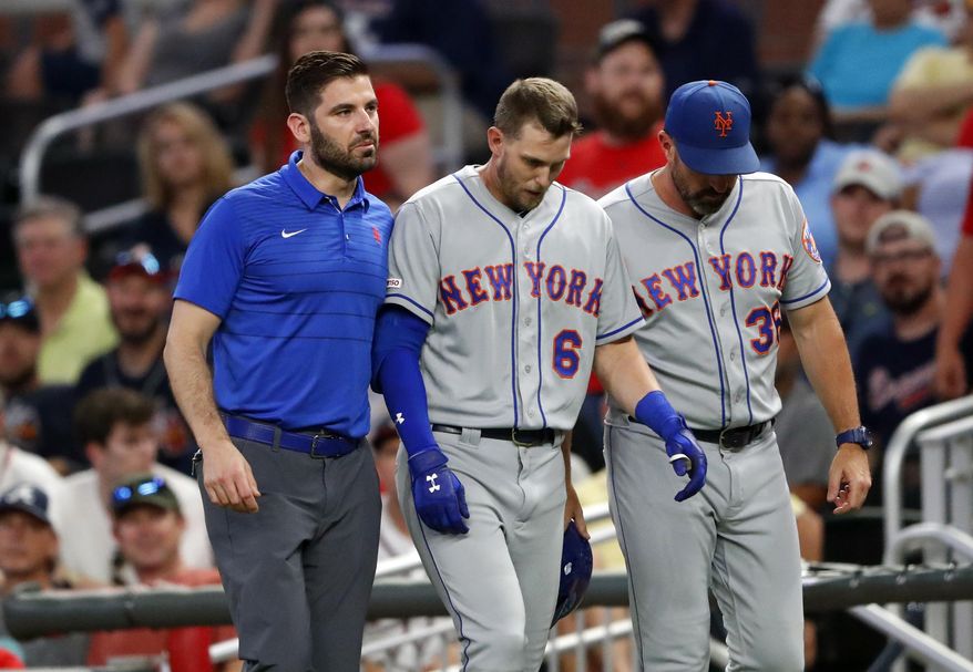 New York Mets&#x27; Jeff McNeil (6) is helped off the field by a trainer and manager Mickey Callaway (36) after being injured running out a ground ball during the ninth inning of the team&#x27;s baseball game against the Atlanta Braves on Tuesday, Aug. 13, 2019, in Atlanta. The Braves won 5-3. (AP Photo/John Bazemore)