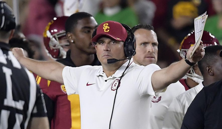 FILE - In this Nov. 24, 2018, file photo, Southern California head coach Clay Helton gestures during the first half of an NCAA college football game against Notre Dame in Los Angeles. Helton went 21-6 with a Rose Bowl victory and Pac-12 title in his first two full seasons as USC coach, but his job status is one of the stories of the 2019 season. (AP Photo/Mark J. Terrill, File)