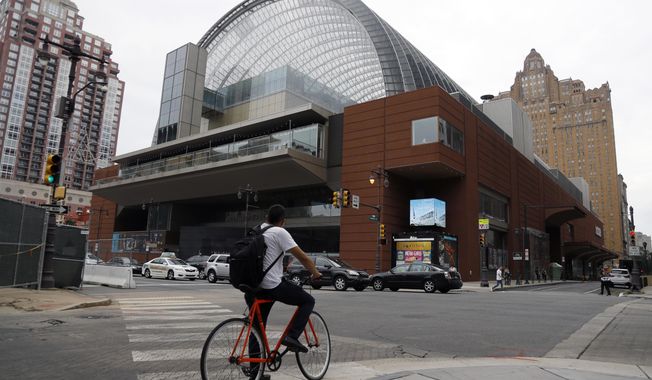 A cyclist passes by The Kimmel Center for the Performance Arts, Tuesday, Aug. 13, 2019, in Philadelphia. The Philadelphia Orchestra has canceled upcoming performances there due to coronavirus concerns, but said on March 12, 2020, that that evening&#x27;s performances will be streamed for free online. (AP Photo/Matt Slocum) **FILE**