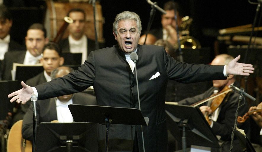 In this Thursday, Jan. 22, 2004, file photo, Placido Domingo sings during his performance at the National Theater in Santiago, Dominican Republic. Nine women in the opera world have told The Associated Press that Domingo, one of the most celebrated and powerful men in the industry, tried to pressure them into sexual relationships and sometimes punished women professionally when they refused his advances. (AP Photo/Miguel Gomez, File)
