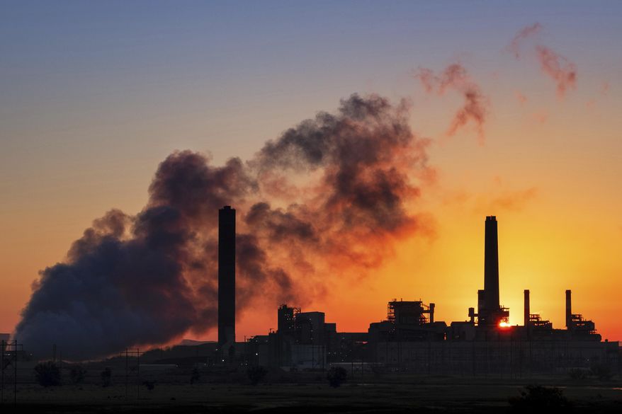 In this July 27, 2018, file photo, the Dave Johnson coal-fired power plant is silhouetted against the morning sun in Glenrock, Wyo. (AP Photo/J. David Ake, File) **FILE**