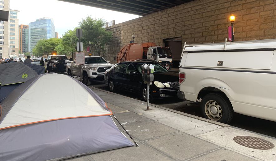D.C. Department of Public Works employees prepare to clear away a homeless encampment under the overpass at First and G streets NE on Tuesday, Aug. 13, 2013. (Sophie Kaplan/The Washington Times)