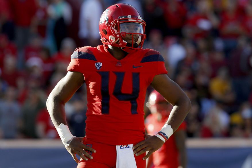 Arizona quarterback Khalil Tate (14) looks on in the second half during an NCAA college football game against Arizona State, Saturday, Nov. 24, 2018, in Tucson, Ariz. Arizona is looking for more consistency after a disappointing first season under coach Kevin Sumlin. The Wildcats return several key players, led by quarterback Khalil Tate and running back J.J. Taylor. Arizona opens its season playing at Hawaii on Aug. 24. (AP Photo/Rick Scuteri)