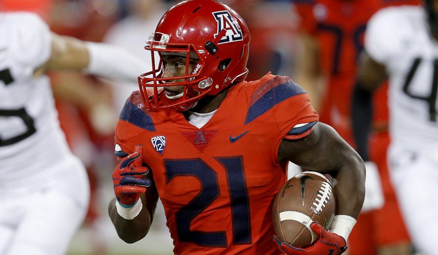 Arizona running back J.J. Taylor (21) runs during an NCAA college football game against Oregon, Saturday, Oct. 27, 2018, in Tucson, Ariz. Arizona is looking for more consistency after a disappointing first season under coach Kevin Sumlin. The Wildcats return several key players, led by quarterback Khalil Tate and running back J.J. Taylor. Arizona opens its season playing at Hawaii on Aug. 24. (AP Photo/Rick Scuteri)