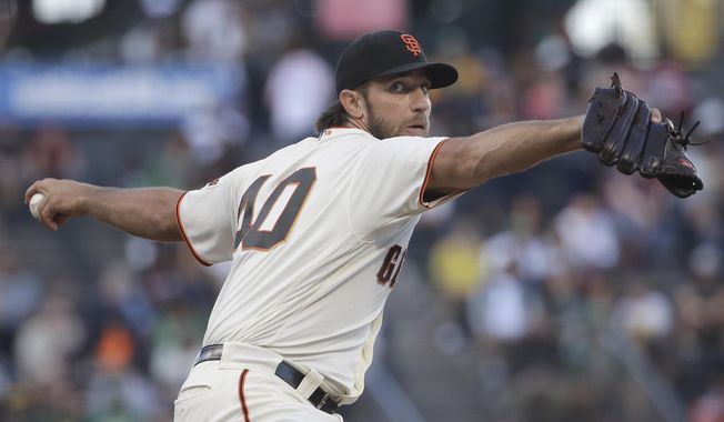 San Francisco Giants pitcher Madison Bumgarner throws to an Oakland Athletics batter during the first inning of a baseball game in San Francisco, Tuesday, Aug. 13, 2019. (AP Photo/Jeff Chiu)