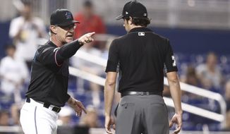 Miami Marlins manager Don Mattingly yells towards umpire John Tumpane after a balk call was made on Miami Marlins starting pitcher Caleb Smith during the fifth inning of the team&#39;s baseball game against the Atlanta Braves on Friday, Aug. 9, 2019, in Miami. Mattingly was thrown out of the game. (AP Photo/Brynn Anderson)