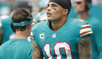 FILE - In this Dec. 9, 2018, file photo, Miami Dolphins wide receiver Kenny Stills (10) stands along the sideline during the first half of the team&#39;s NFL football game against the New England Patriots in Miami Gardens, Fla. Dolphins owner Stephen Ross is defending his support of longtime friend Donald Trump after being criticized about it by Stills. (AP Photo/Wilfredo Lee, File)