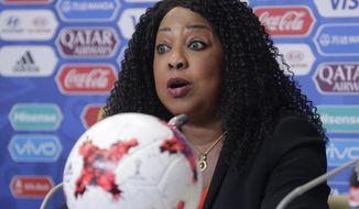 FILE - In this Friday, June 16, 2017 file photo, FIFA Secretary General Fatma Samoura talks to media at the St. Petersburg Stadium in Russia.  In a letter sent Monday Aug. 12, 2019, to national soccer associations, Samoura, was supposed to delegate her functions to avoid conflict of interests while she conducted a six-month role as FIFA General Delegate for Africa, but she is now seeking approval from African soccer nations for FIFA to take control of the sale of television rights for Africa’s World Cup qualifiers. (AP Photo/Dmitri Lovetsky, File)