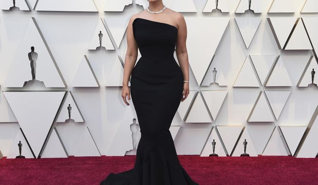 FILE - In this Feb. 24, 2019 file photo, Ashley Graham arrives at the Oscars at the Dolby Theatre in Los Angeles.  Graham announced she’s pregnant with her first child in time to celebrate her ninth wedding anniversary with filmmaker Justin Ervin. The two shared a short video on Instagram showing off Graham’s growing bump. She wished her husband happy anniversary and said their lives are “about to get even better.” (Photo by Richard Shotwell/Invision/AP, File)