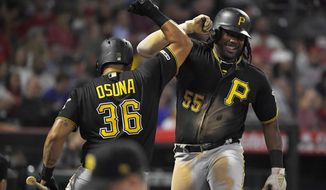 Pittsburgh Pirates&#39; Josh Bell, right, is congratulated by Jose Osuna after hitting a two-run home run during the fifth inning of the team&#39;s baseball game against the Los Angeles Angels on Tuesday, Aug. 13, 2019, in Anaheim, Calif. (AP Photo/Mark J. Terrill)