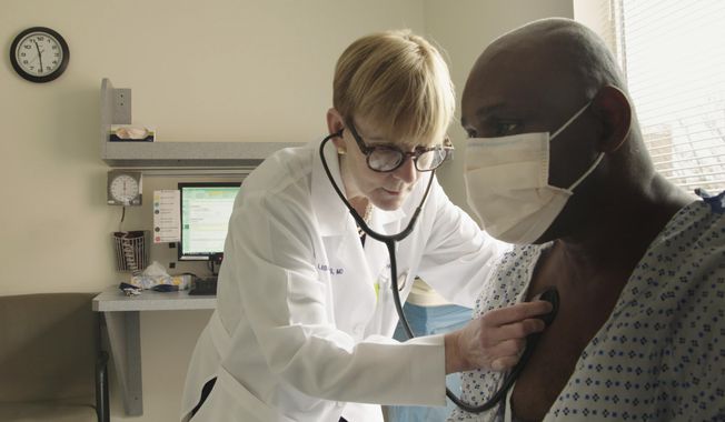 This photo provided by Netflix shows Dr. Lisa Sanders examining a patient in a scene from the new Netflix series “Diagnosis,” which transports Sanders’ column from the pages of The New York Times to television. The show, which is available starting Friday, Aug. 16, 2019, harnesses the internet and social media to diagnose unusual cases.  (Netflix via AP)