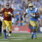 FILE - In this Nov. 17, 2018, file photo, UCLA running back Joshua Kelley, right, runs for a touchdown against Southern California during the second half of an NCAA college football game in Pasadena, Calif. The offense returns nine starters, including sophomore quarterback Dorian Thompson-Robinson and senior running back Joshua Kelley, who went for 289 yards in the victory over USC. (AP Photo/Marcio Jose Sanchez, File)