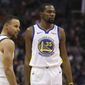 FILE - In this Feb. 8, 2019, file photo, Golden State Warriors guard Stephen Curry (30) and forward Kevin Durant (35) pause during the first half of an NBA basketball game against the Phoenix Suns Friday, Feb. 8, 2019, in Phoenix. Someday, years or even decades from now, at one of those celebratory reunions teams like to do, Stephen Curry knows he and Kevin Durant will reminisce with fondness about their three insanely successful years together on the Golden State Warriors. They will reflect on the greatness, the fun, all they learned from each other shooting side by side day after day to become better from their time as teammates. Two championships, a pair of NBA Finals MVP awards for Durant. (AP Photo/Ross D. Franklin, File)
