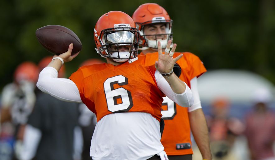 Cleveland Browns quarterback Baker Mayfield (6) throws in front of quarterback David Blough (9) during practice at the NFL team's football training camp in Westfield, Ind., Thursday, Aug. 15, 2019. The Browns held a joint practice with the Indianapolis Colts. (AP Photo/Michael Conroy)