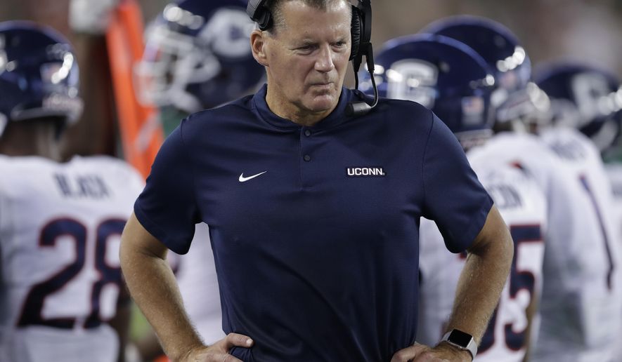 FILE - In this Oct. 20, 2018, file photo, Connecticut head coach Randy Edsall watches from the sideline during the first half of an NCAA college football game against South Florida, in Tampa, Fla. Edsall doesn’t talk about conference championships or bowl games when he speaks of the Huskies’ goals for their final season in the American Athletic Conference. He just wants to see his football team improve. It would be hard for the Huskies to get much worse than they were a year ago .(AP Photo/Chris O&#39;Meara, File)