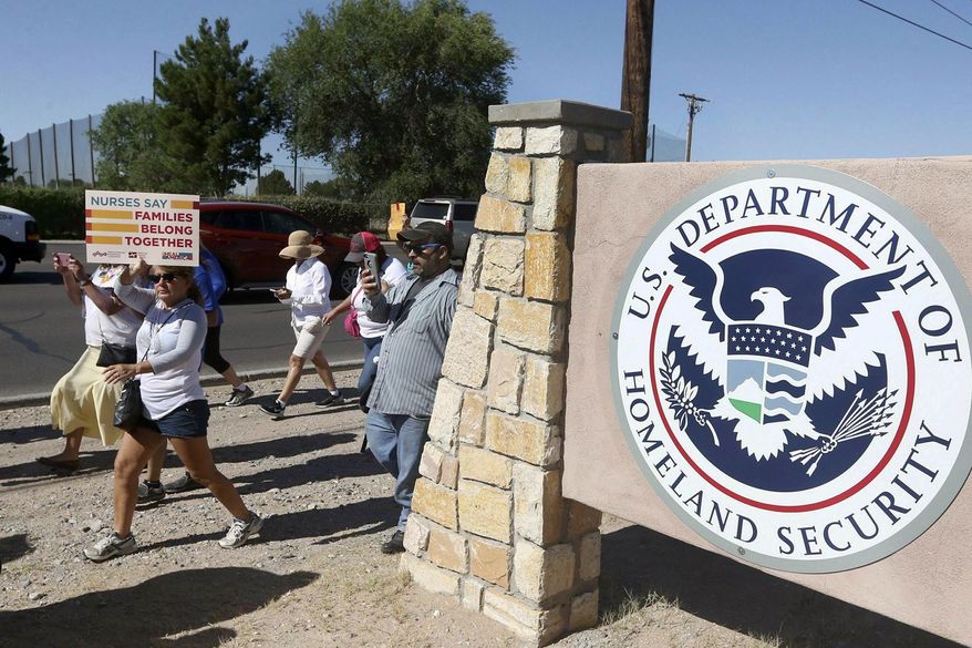 In this June 2018, photo, protesters walk along Montana Avenue outside the El Paso Processing Center in El Paso, Texas. (Rudy Gutierrez/The El Paso Times via AP) **FILE**
