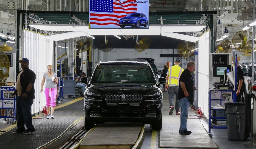 FILE - In this June 24, 2019, file photo Ford's employees work on a Lincoln Aviator line at Ford's Chicago Assembly Plant in Chicago's Hegewisch neighborhood. On Thursday, Aug. 15, the Federal Reserve reports on U.S. industrial production for July. (AP Photo/Amr Alfiky, File)