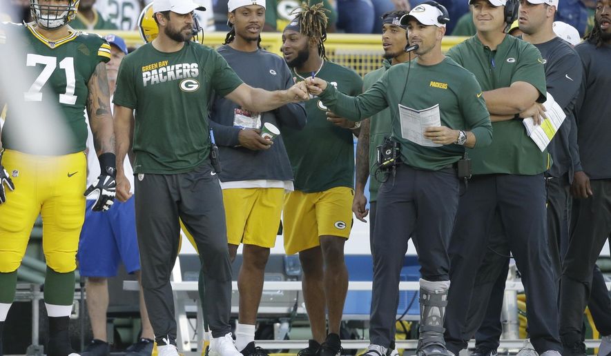 Green Bay Packers quarterback Aaron Rodgers and coach Matt LaFleur bump fists during the first half of the team's NFL preseason football game against the Houston Texans on Thursday, Aug. 8, 2019, in Green Bay, Wis. (AP Photo/Jeffrey Phelps)