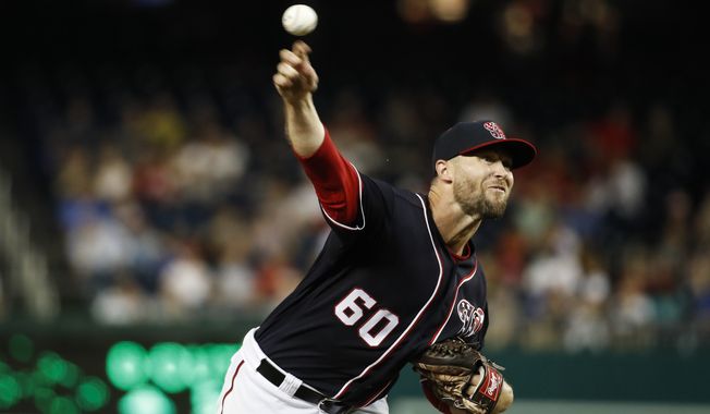 Washington Nationals relief pitcher Hunter Strickland (60) throws during a baseball game against the Milwaukee Brewers at Nationals Park, Friday, Aug. 16, 2019, in Washington. (AP Photo/Alex Brandon) ** FILE **