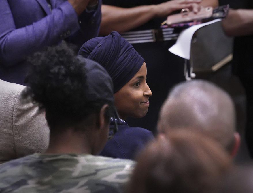 U.S. Rep. Ilhan Omar reacts after being introduced in the Minneapolis City Council Chambers before Minneapolis Mayor Jacob Frey&#39;s budget address Thursday, Aug. 15, 2019, in Minneapolis. (Brian Peterson/Star Tribune via AP)